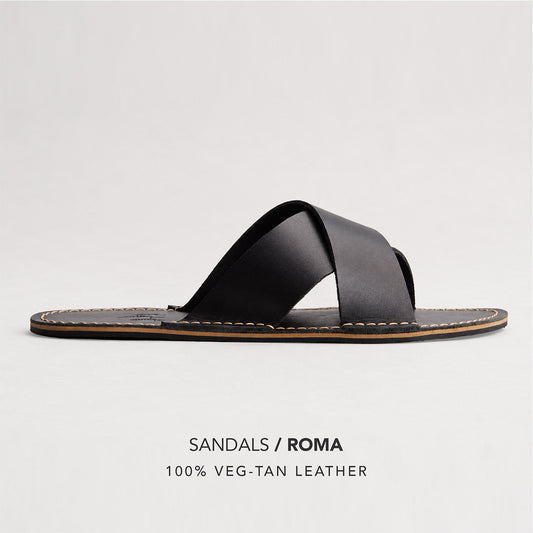 Nero | Flat leather sandal with debossed PLG three tree logo in sole, text reads "Sandals Roma 100% Veg Tan Leather"
