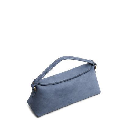 Denim | Leather bowler bag with magnetic closure against a white background