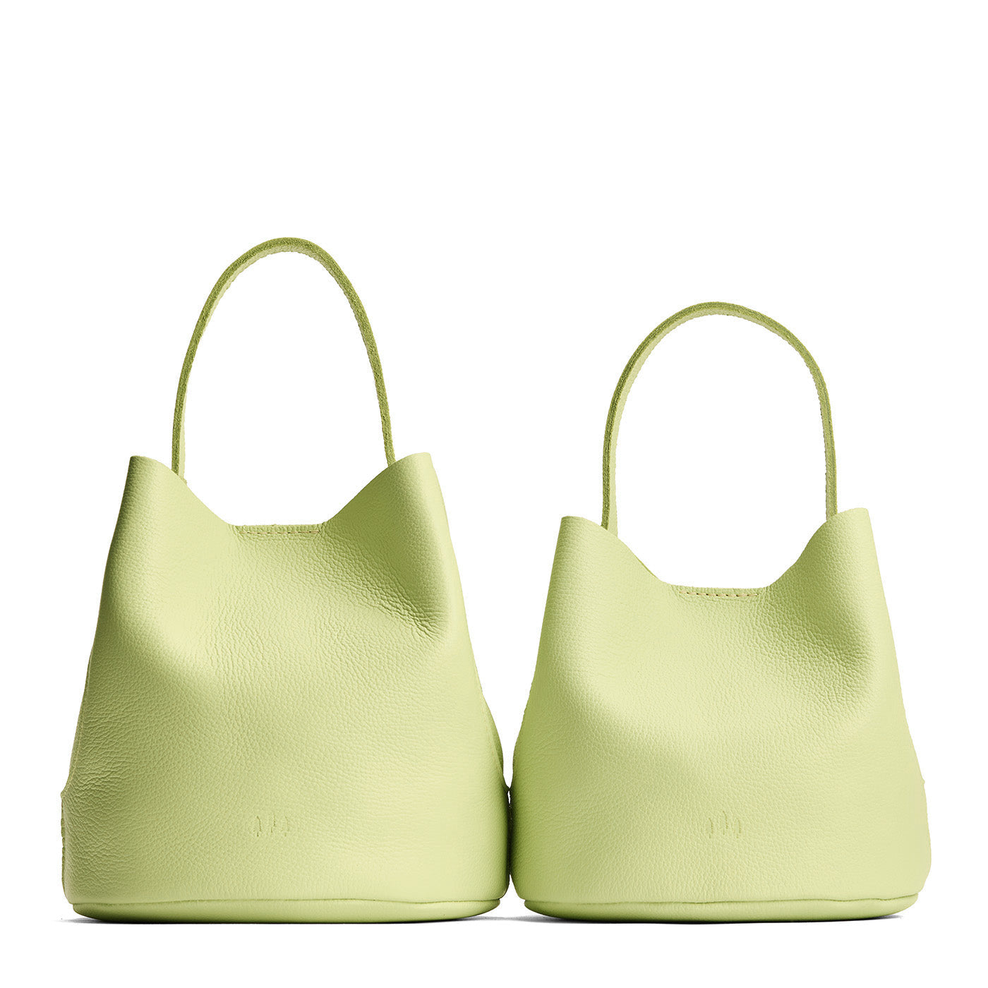 Shadow Lime | Size comparison image of two symmetrical leather bucket bags