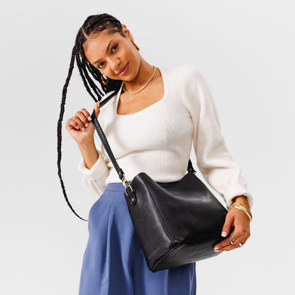 Pebbled--black | symmetrical bucket bag with latch closure and removable crossbody strap