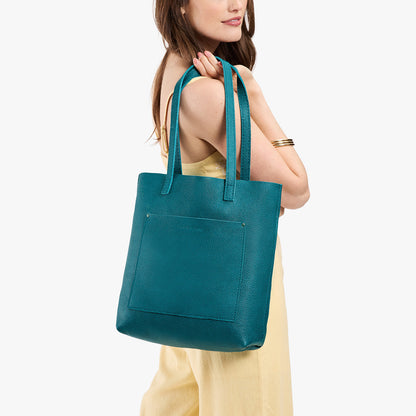 Aquarius*Classic | Model holding medium Tote with dual shoulder straps and crossbody strap