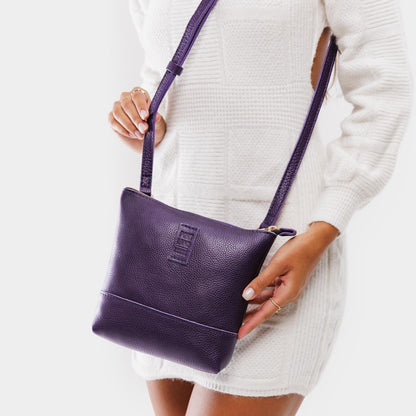 Empire | Model wearing small rectangular crossbody purse with top zipper and interior pocket