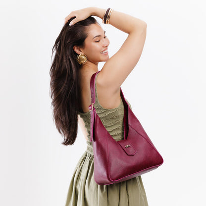 Orchid | Model wearing structured hobo shoulder bag with adjustable strap and magnetic closure