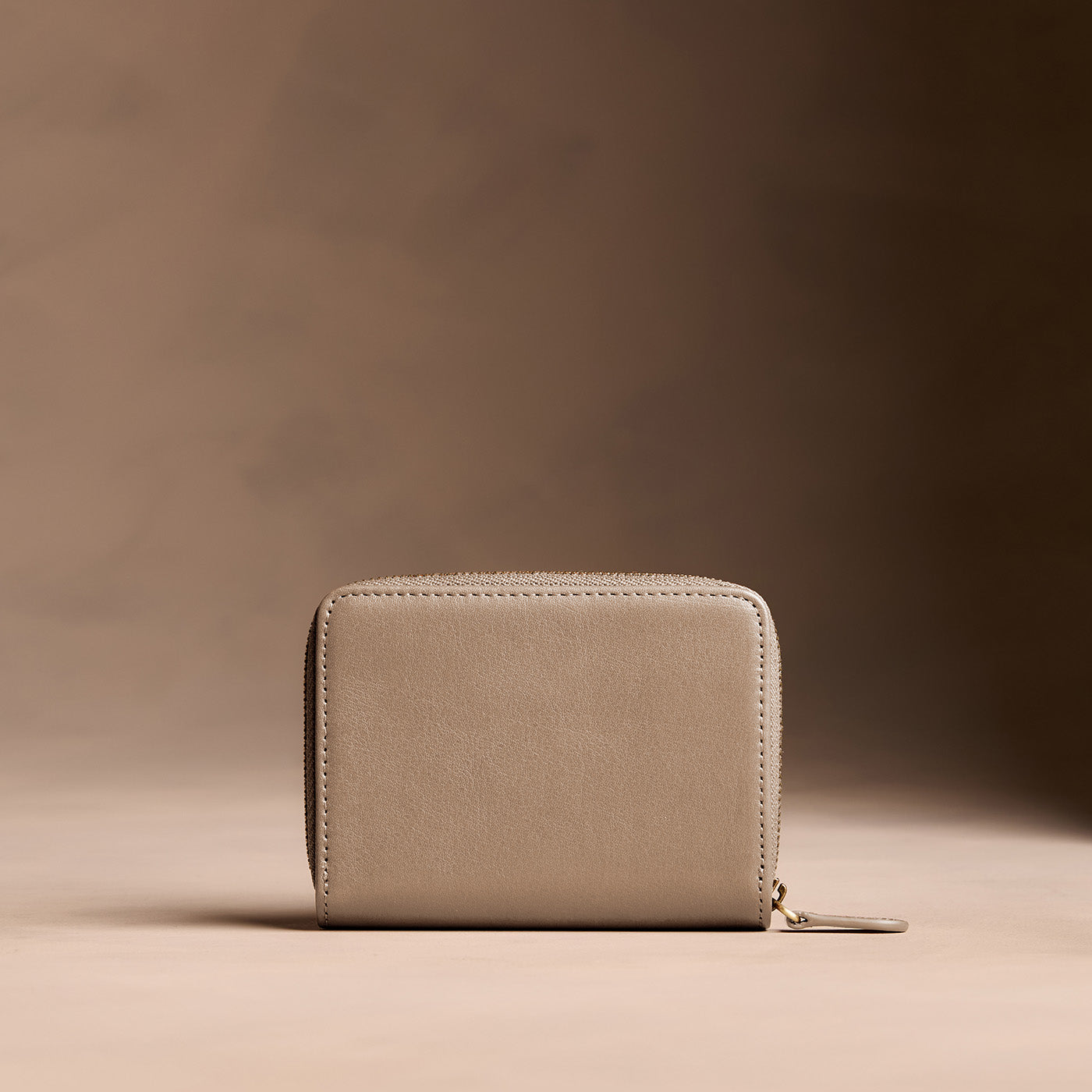Satine | Wallet with card and storage pockets on a light brown background - back view