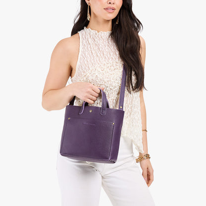 Empire*Classic | Model holding crossbody tote bag with snap closure and front pocket