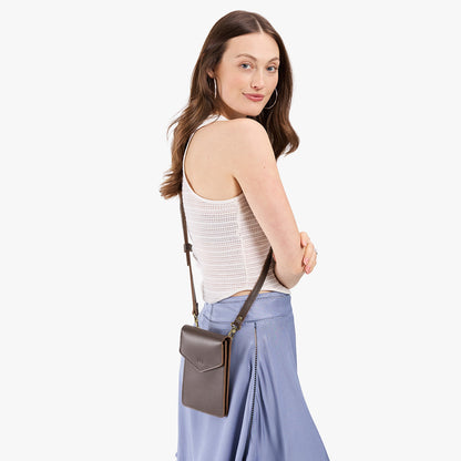 Grizzly | Model wearing slim, phone-shaped crossbody purse with magnetic closure