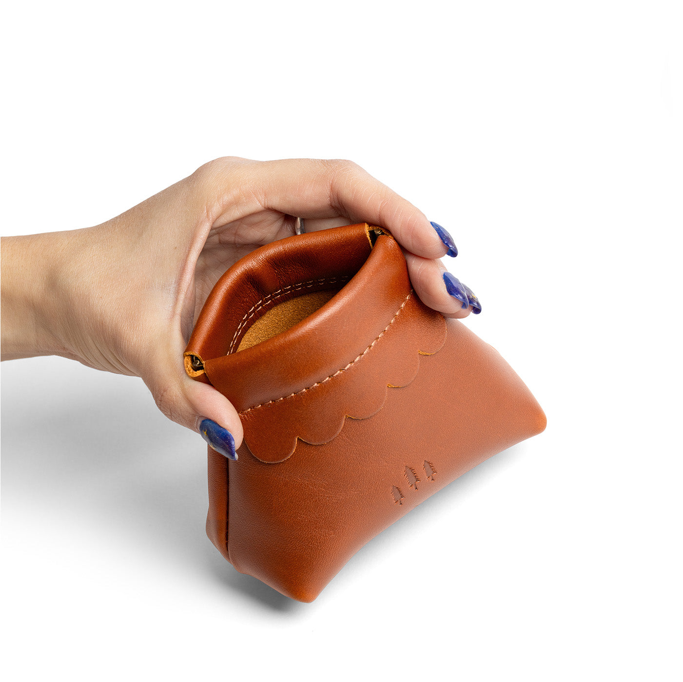 Honey | Hand holding leather coin pouch with scalloped edge and three Portland leather tree emblems open