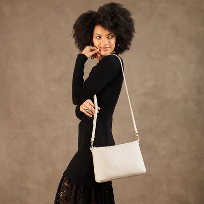 Pebbled Bone*Large | Model wearing a zip top crossbody bag with detachable strap