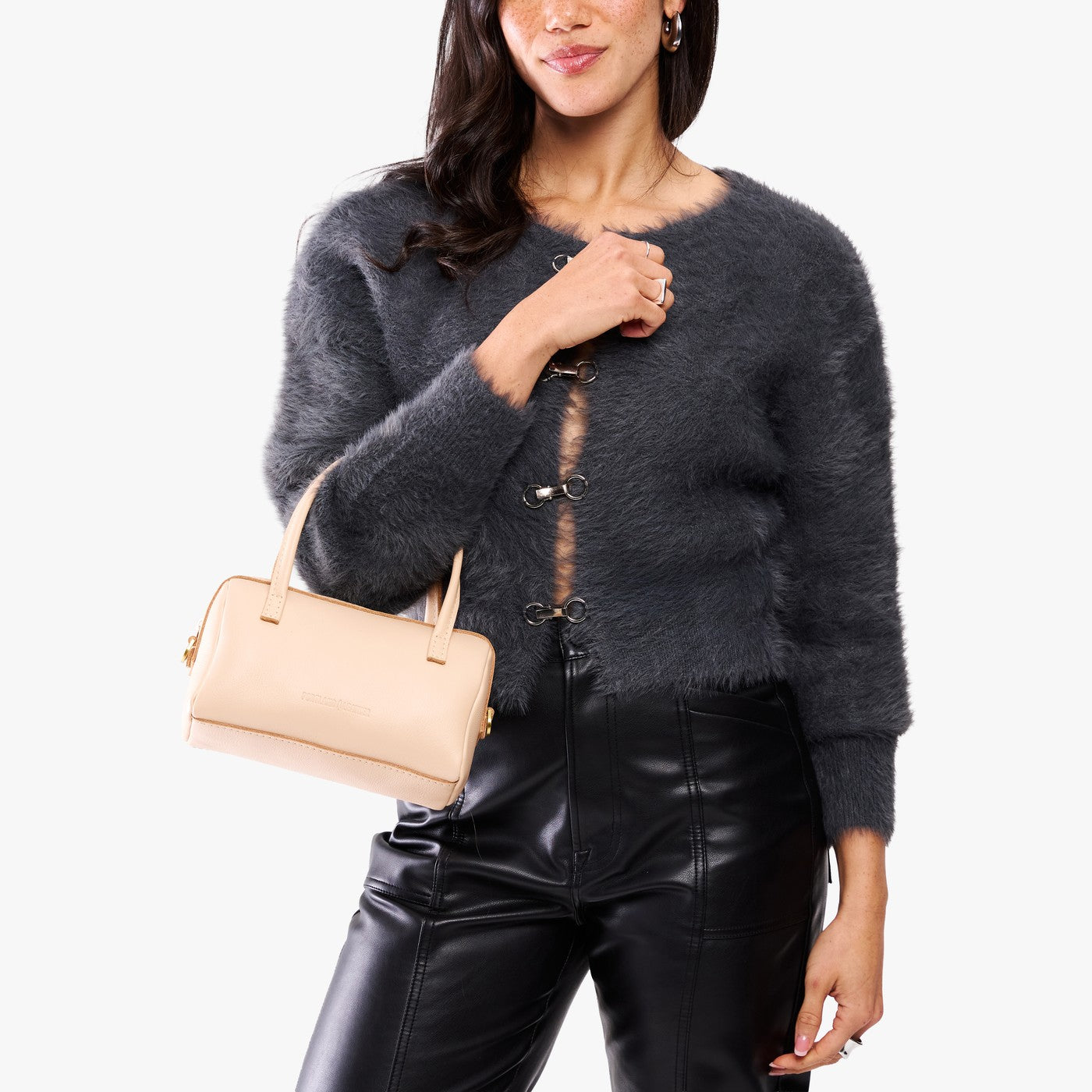 Moonflower*Small | Model holding mini duffle shaped handbag with crossbody strap