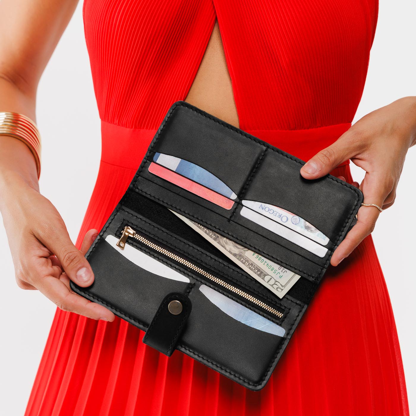 Black | Model holding leather wallet with snap open
